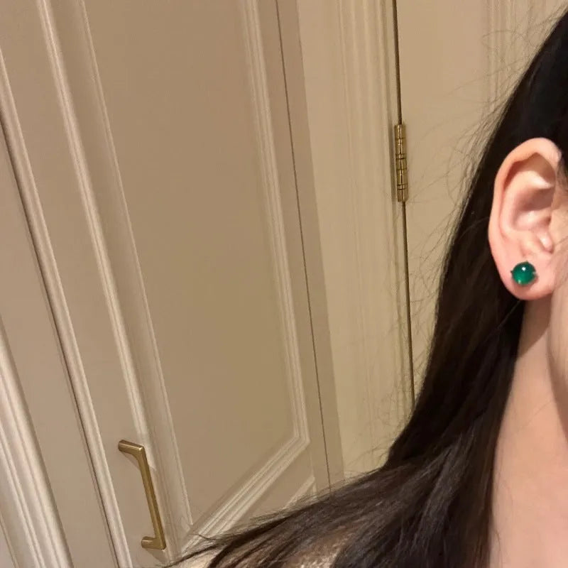 Chinese style chalcedony stud earrings with four-claw stone settings and round geometric design