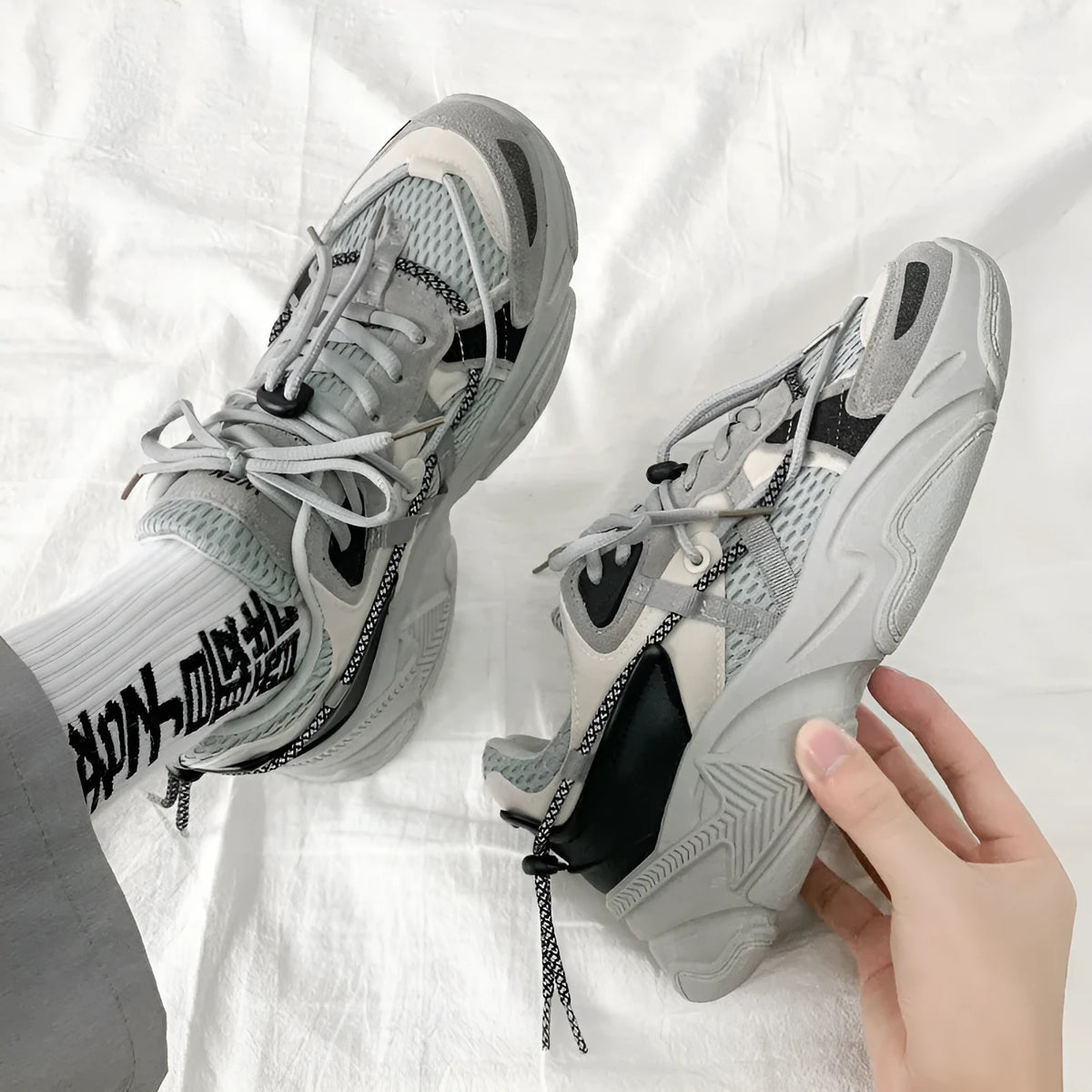 Men's white Korean style platform dad shoes with front lace-up closure on a neutral background.
