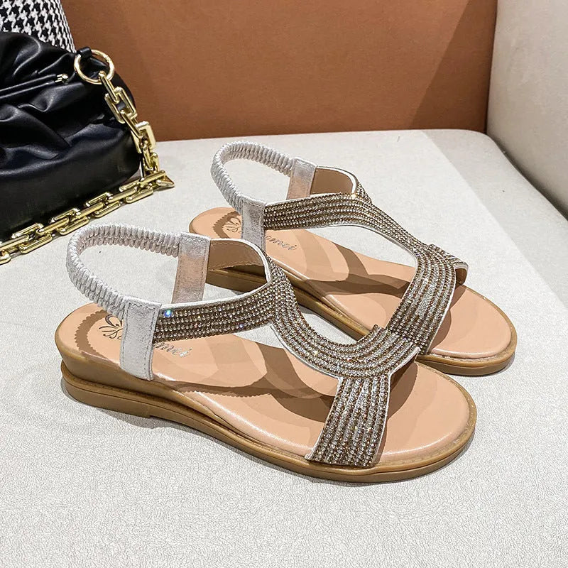 Gold patent leather women's thong sandals with rhinestone accents and a non-slip sole.