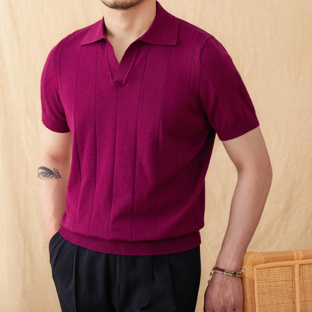 Man wearing a purple knitted short sleeve polo shirt with a seagull collar and sunken stripe pattern.