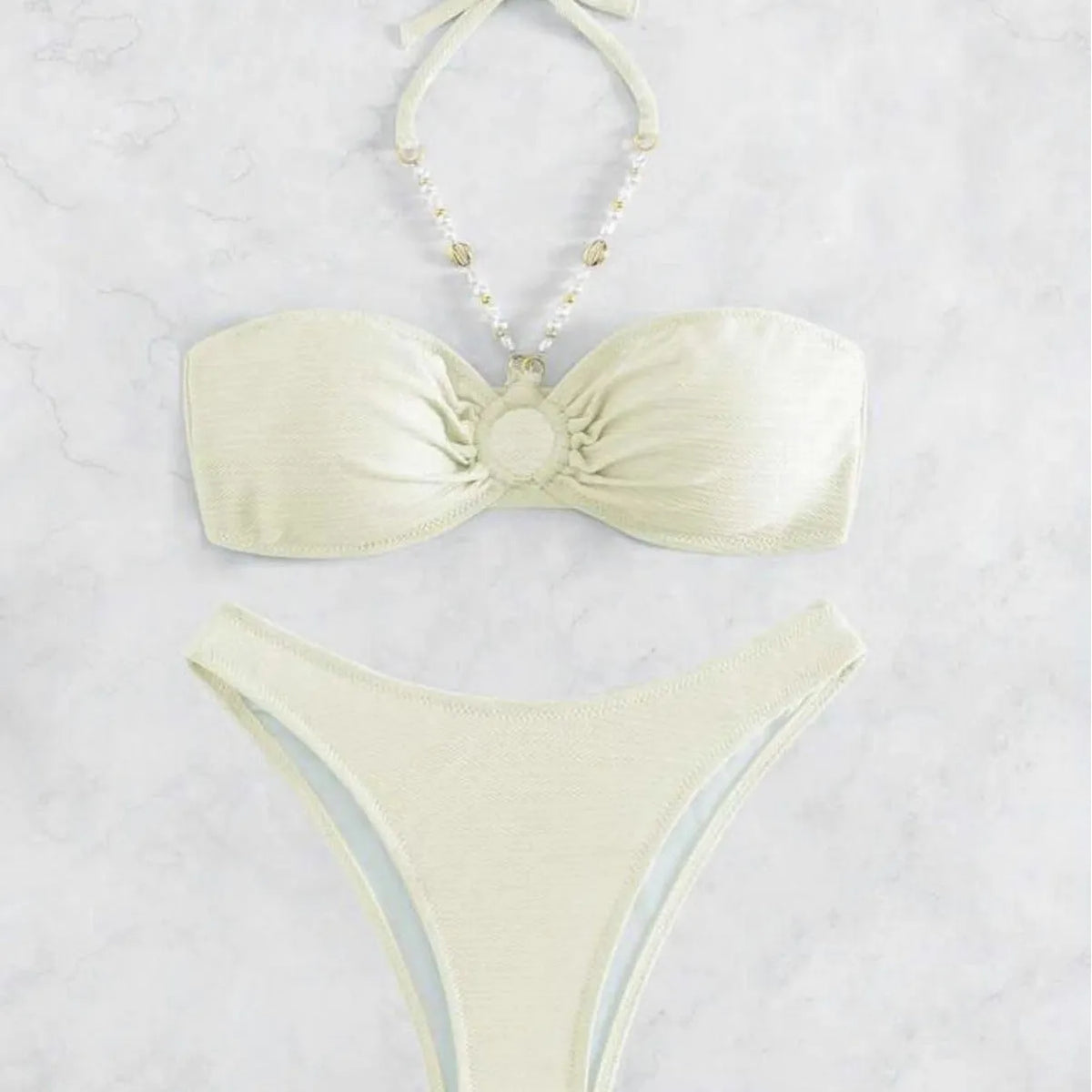 Women's pure colour halter neck bikini set on a hanger, shown in creamy-white.