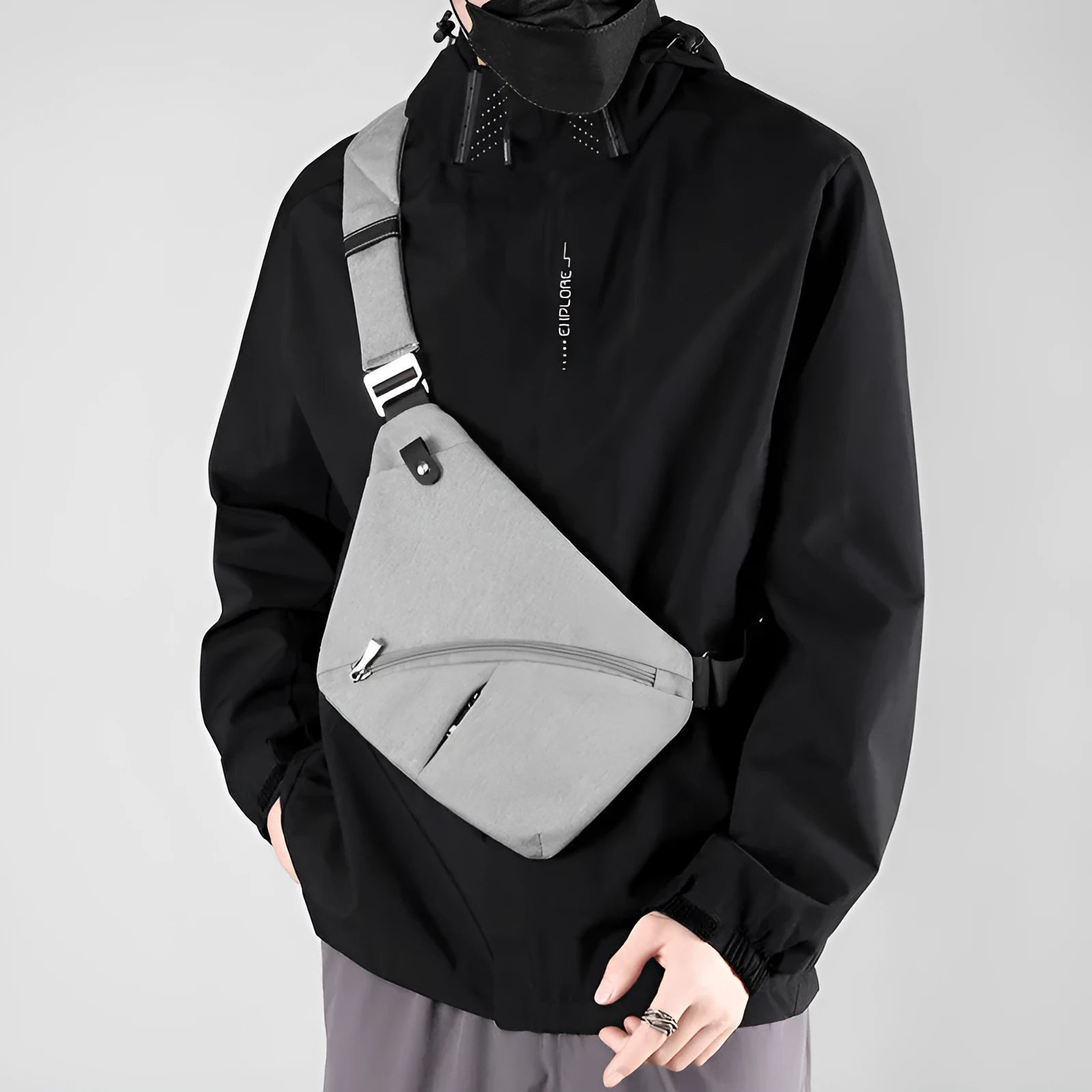 Black Oxford cloth men's chest bag with one shoulder strap and urban letter detail.