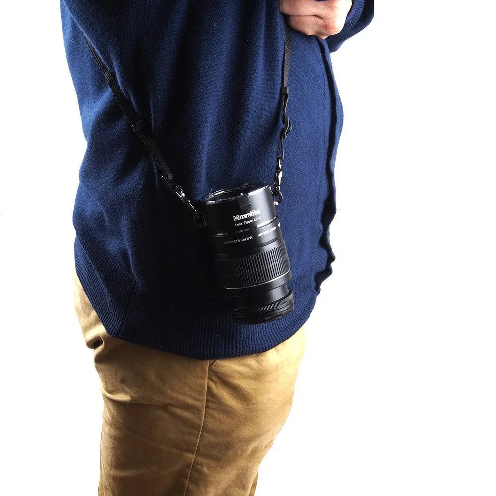Aluminium camera lens flipper holder for Nikon F-mount with cotton shoulder strap.