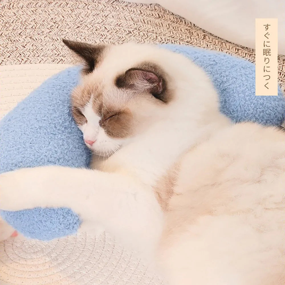 U-shaped blue cat pillow with adjustable fabric collar on a sofa