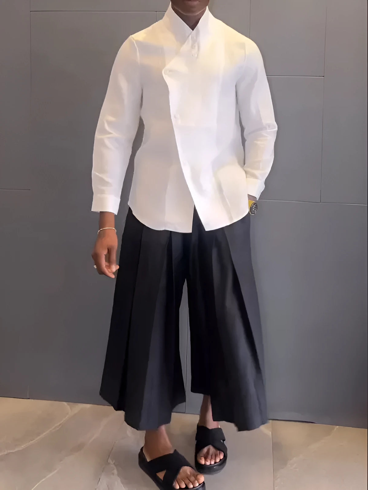 White asymmetric long sleeve shirt paired with black pleated pants in casual two-piece set