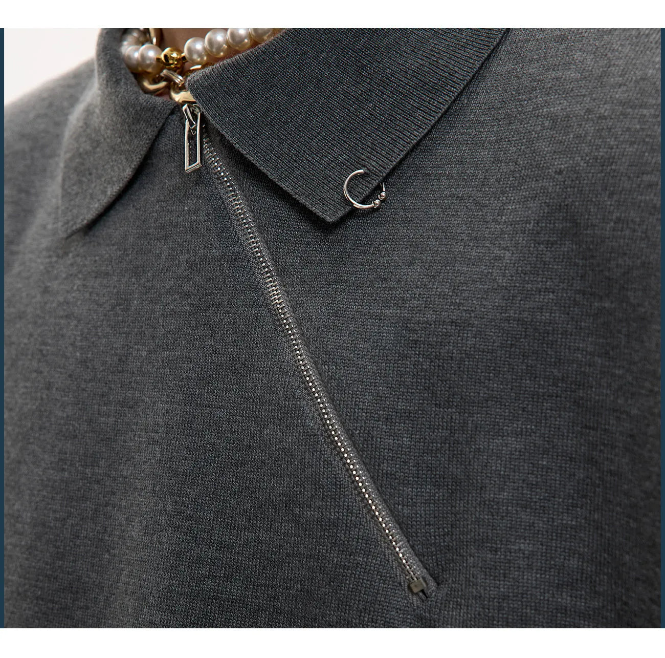 Man modelling a slim-fit black knitted polo shirt with a diagonal oblique zip and lapel collar.