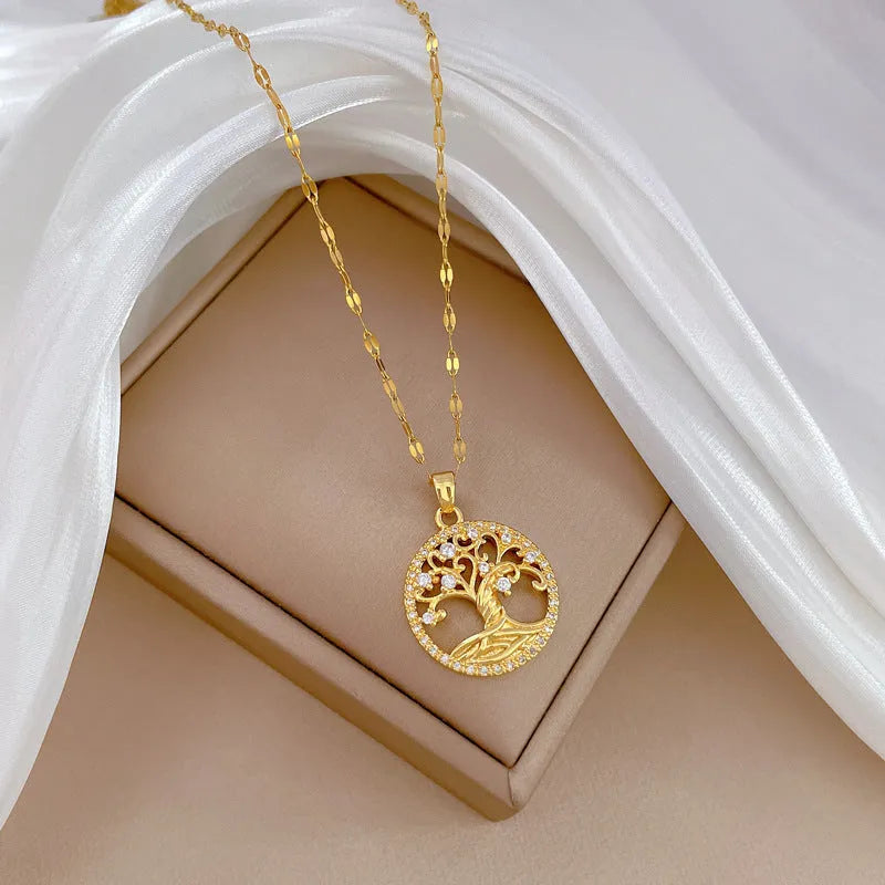 Gold plated necklace with tree and cross pendant featuring mother of pearl and rhinestones on adjustable chain