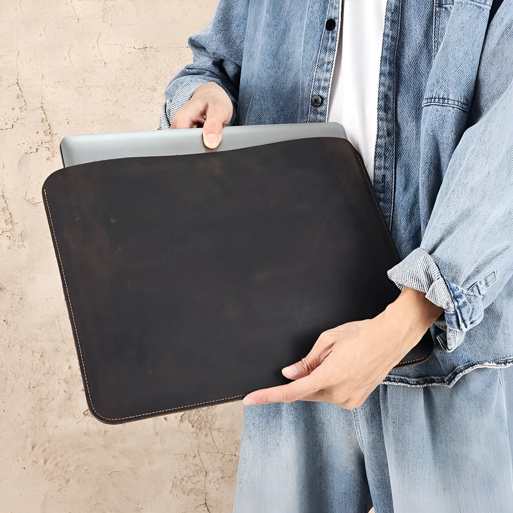 Brown genuine cowhide leather horizontal computer liner bag with a solid colour pattern.