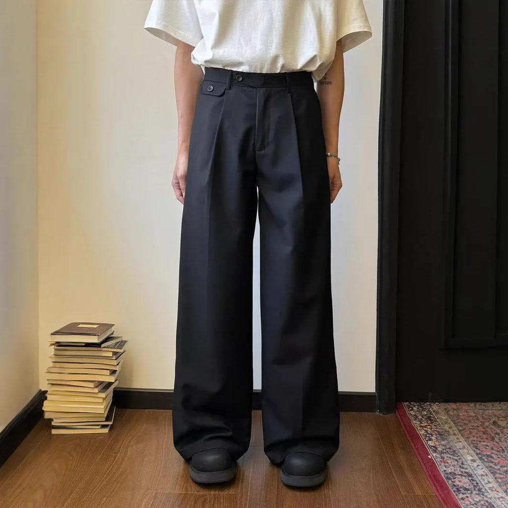 Men's loose-fitting straight-leg trousers in brown and black colours on a hanger