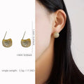 Geometric drop earrings with diamond-encrusted golden beans in gold or white