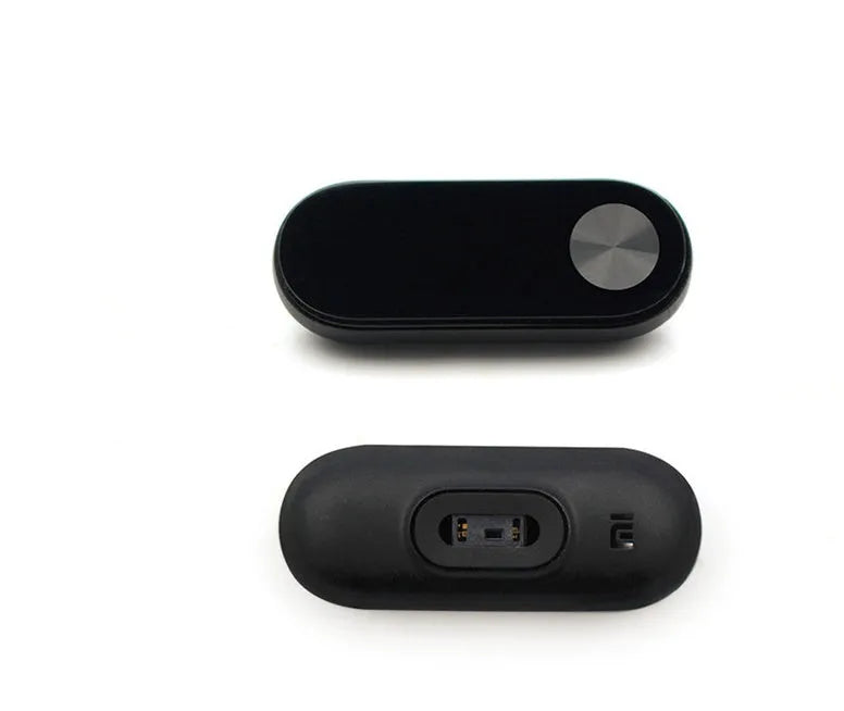 Black Xiaomi Mi Band 2 fitness tracker on wrist showing OLED screen with heart rate data.