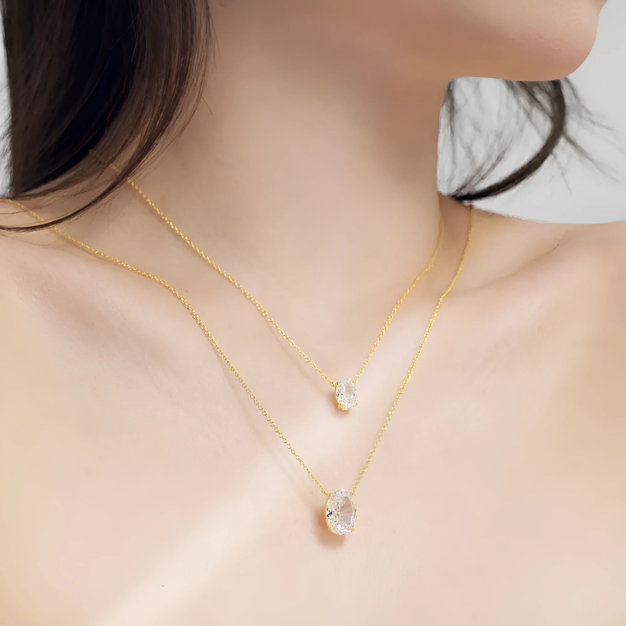 Sterling silver necklace with a geometric oval ice flower pendant in gold or platinum finish.