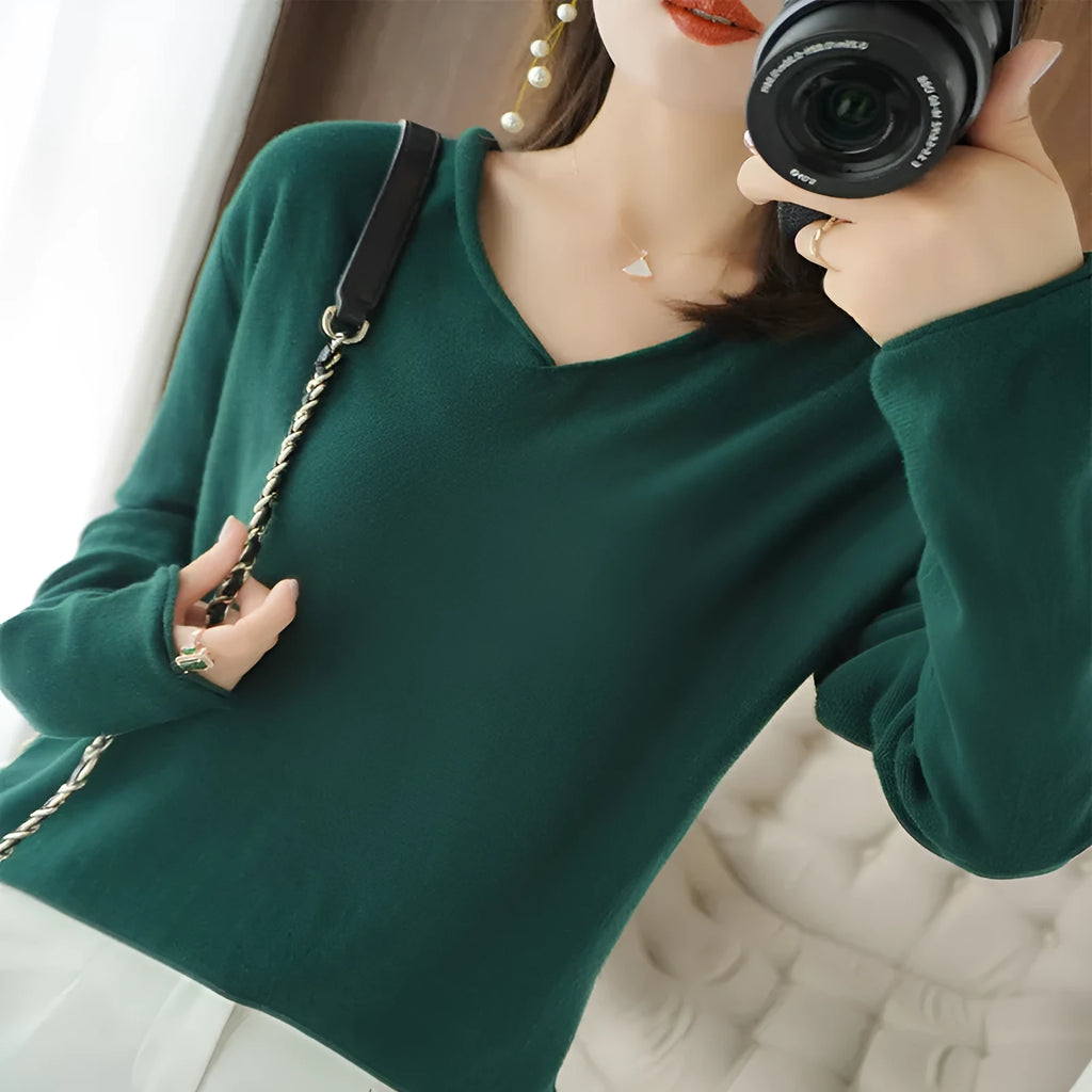 Women's turmeric V-neck long sleeve knitwear top laid flat.