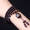 Zambian rosewood bead bracelet with flat lotus pendant showing 108 individual 0.6cm wooden beads