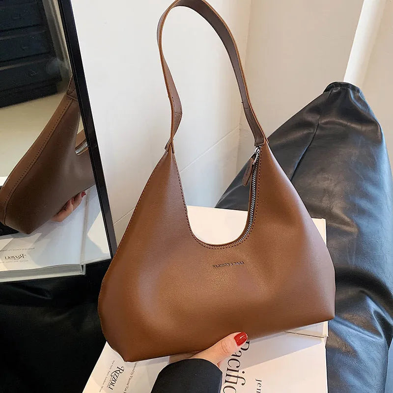 Brown retro PU leather shoulder handbag with a single strap, pillow shape, and stitching detail.
