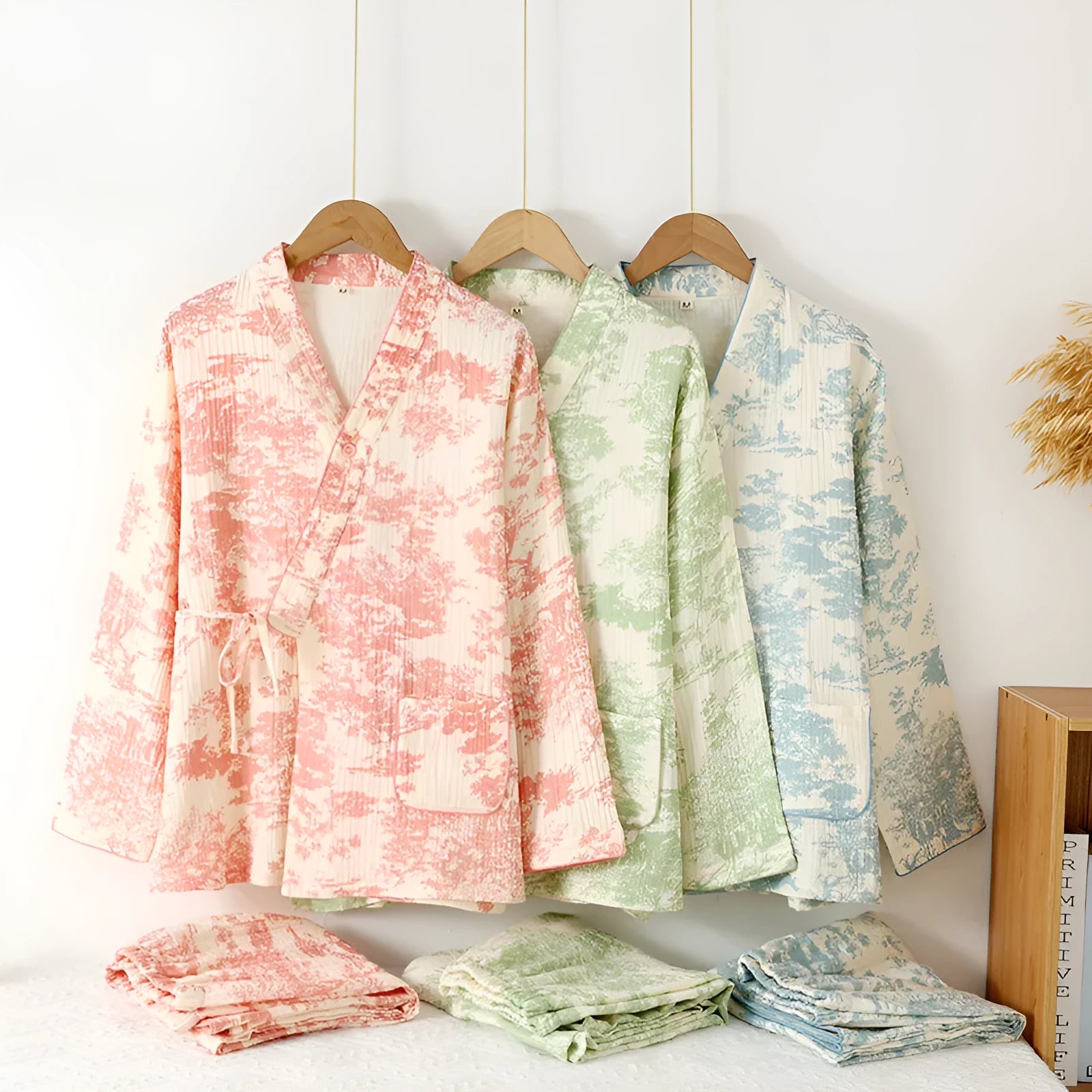 Women's pink pure cotton gauze long sleeve lounge suit with matching trousers on a hanger.