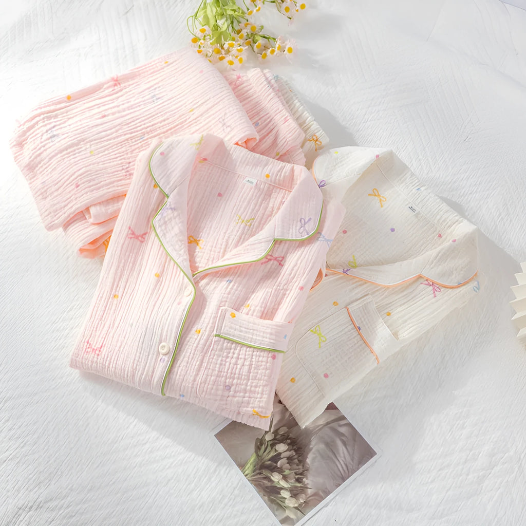 Women's lightweight pink cotton pyjama set with long sleeves and full-length trousers.