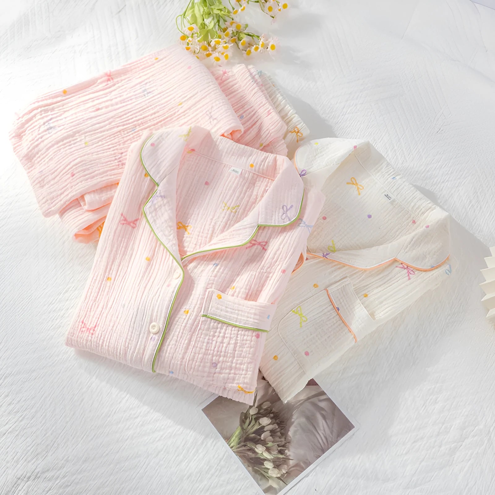 Women's lightweight pink cotton pyjama set with long sleeves and full-length trousers.