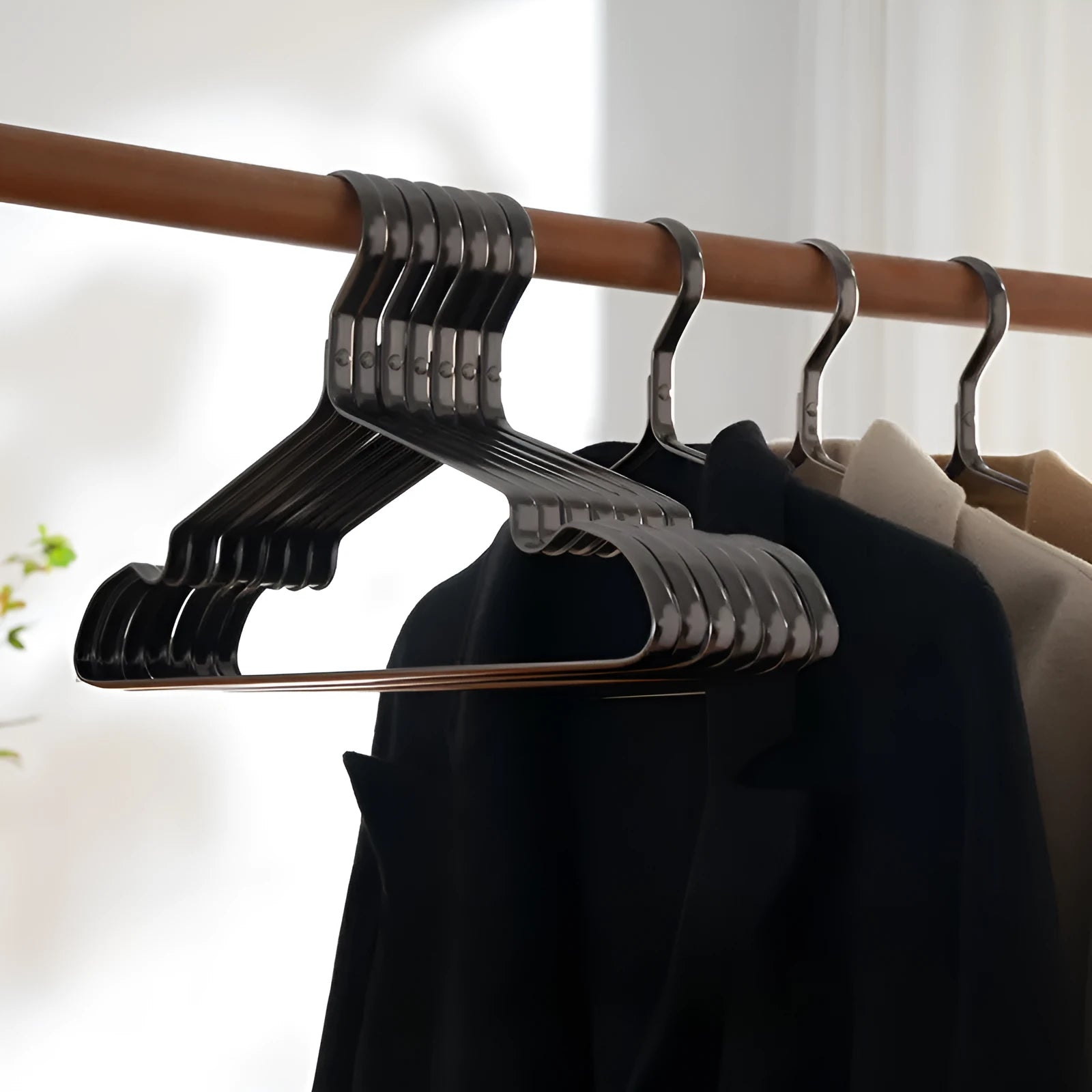 Black plastic clothes hangers with non-slip anti-rust coating for wardrobe organisation