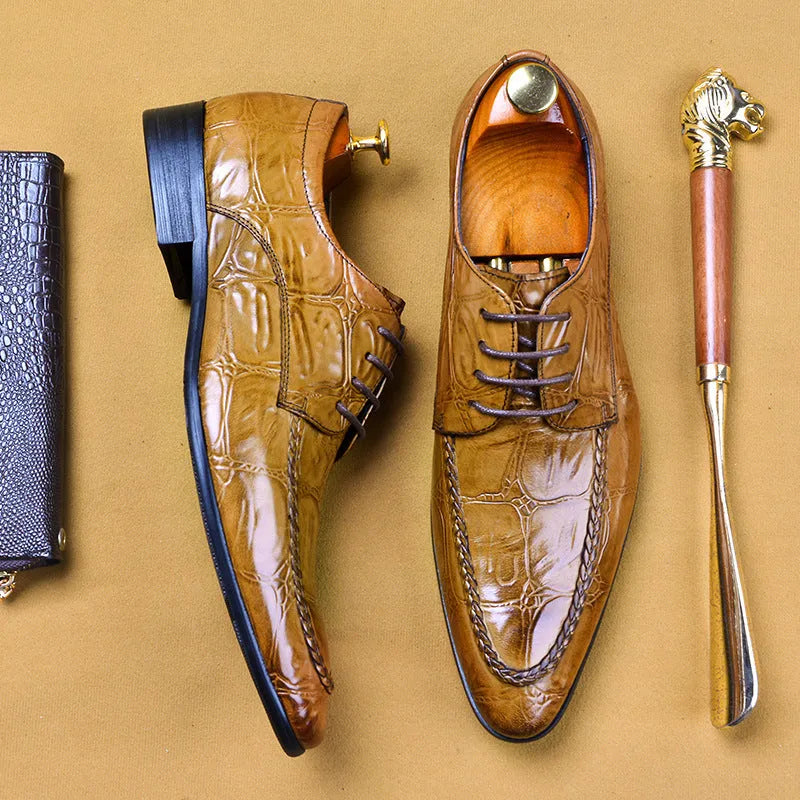 Men's brown leather shoes with alligator pattern texture and a silver horse bit buckle on the front.