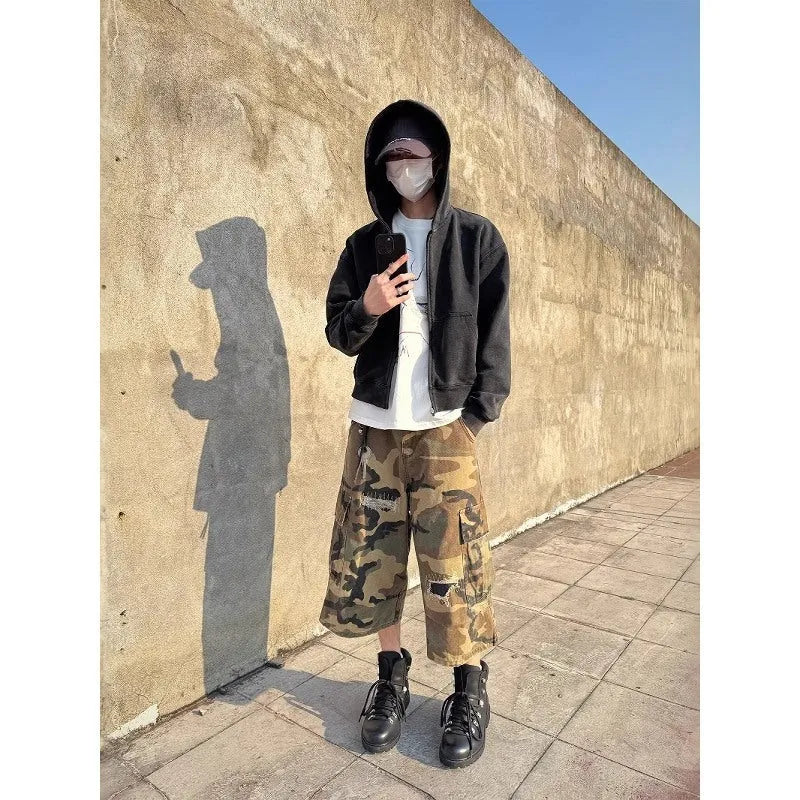 Men's camouflage cropped jeans with patchwork and ripped detailing in straight-leg loose fit