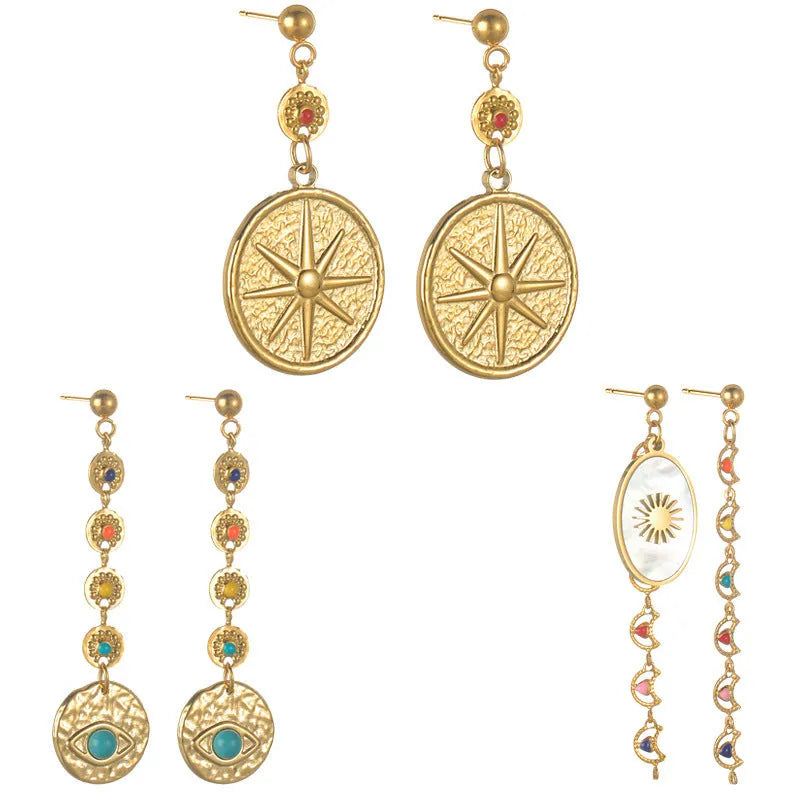 Geometric stainless steel earrings showing eight-avn star, eye, and shell sun designs