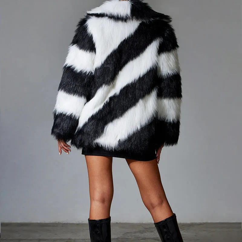 Women's beige faux fur lapel coat with a dark contrast fur collar on a hanger.