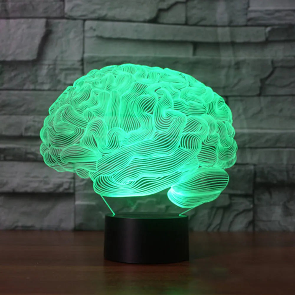 3D acrylic brain-shaped LED lamp with remote control on a wooden desk, projecting colourful light