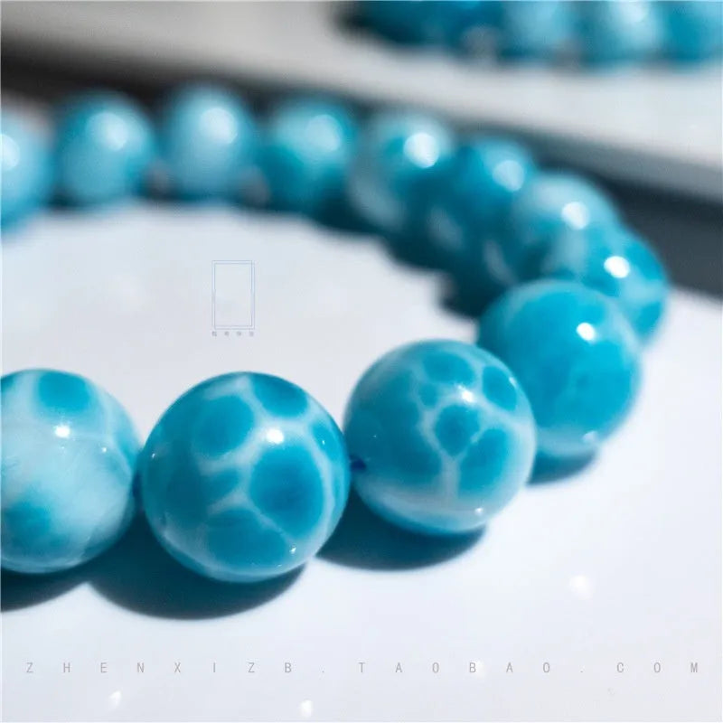 Blue bodhi bracelet with sea-pattern crystal stone and pearl accents in Maillard style.