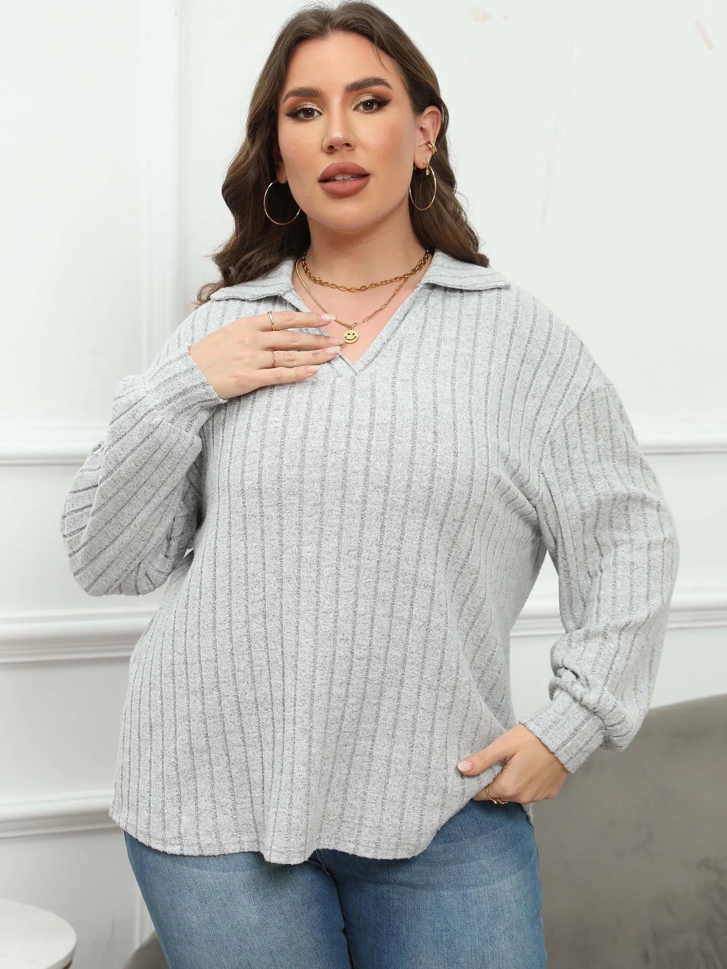 Women's plus size gray polo collar fleece shirt with lantern sleeves on a hanger.
