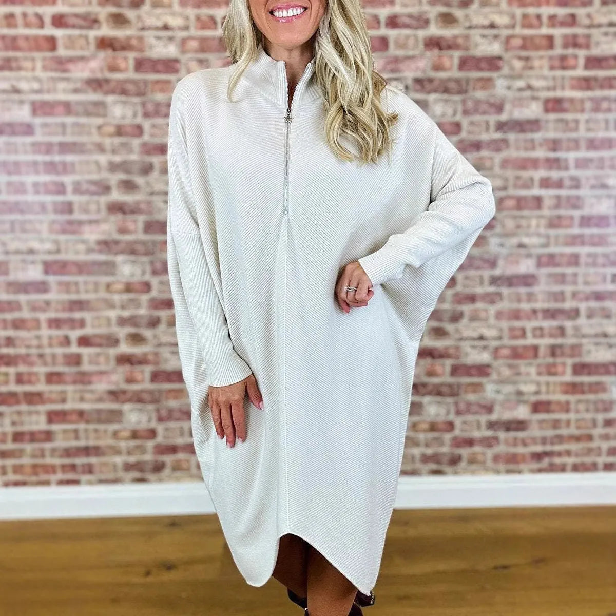 Women's solid colour loose fit knitted dress with raglan sleeves and a front zipper detail.