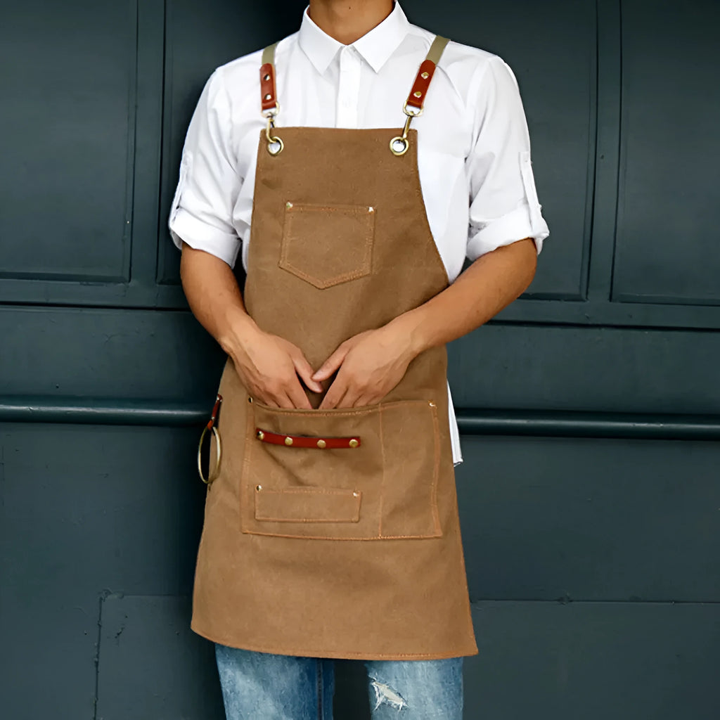 Canvas apron with cross strap back design in camel colour for baking and gardening protection