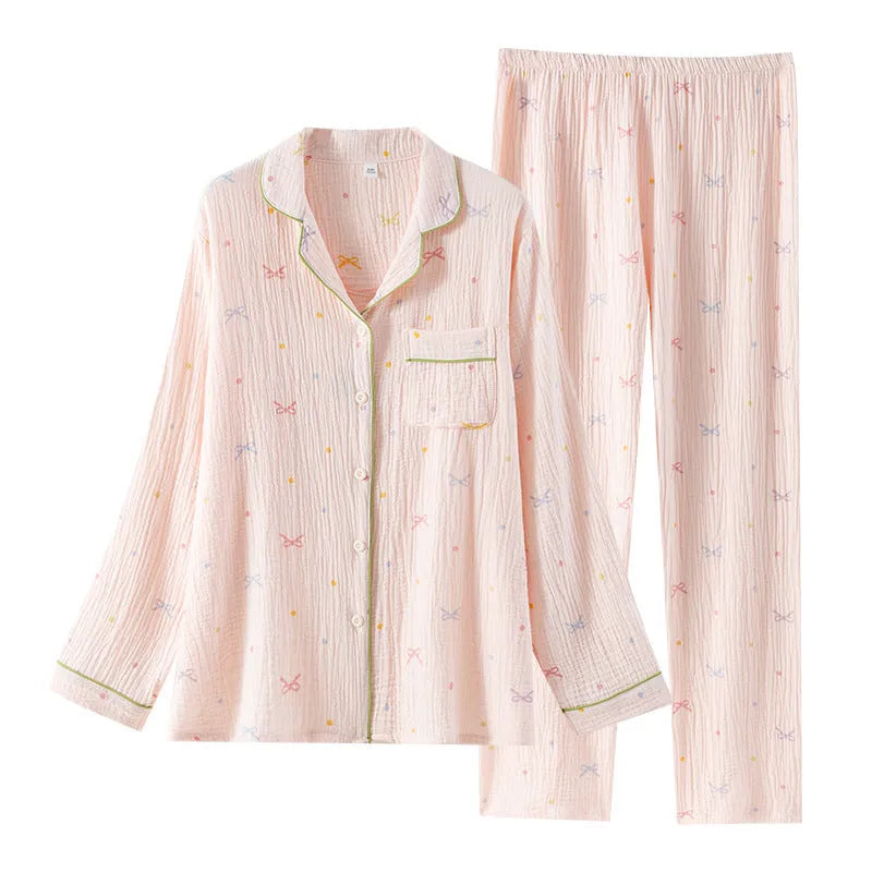 Women's lightweight pink cotton pyjama set with long sleeves and full-length trousers.