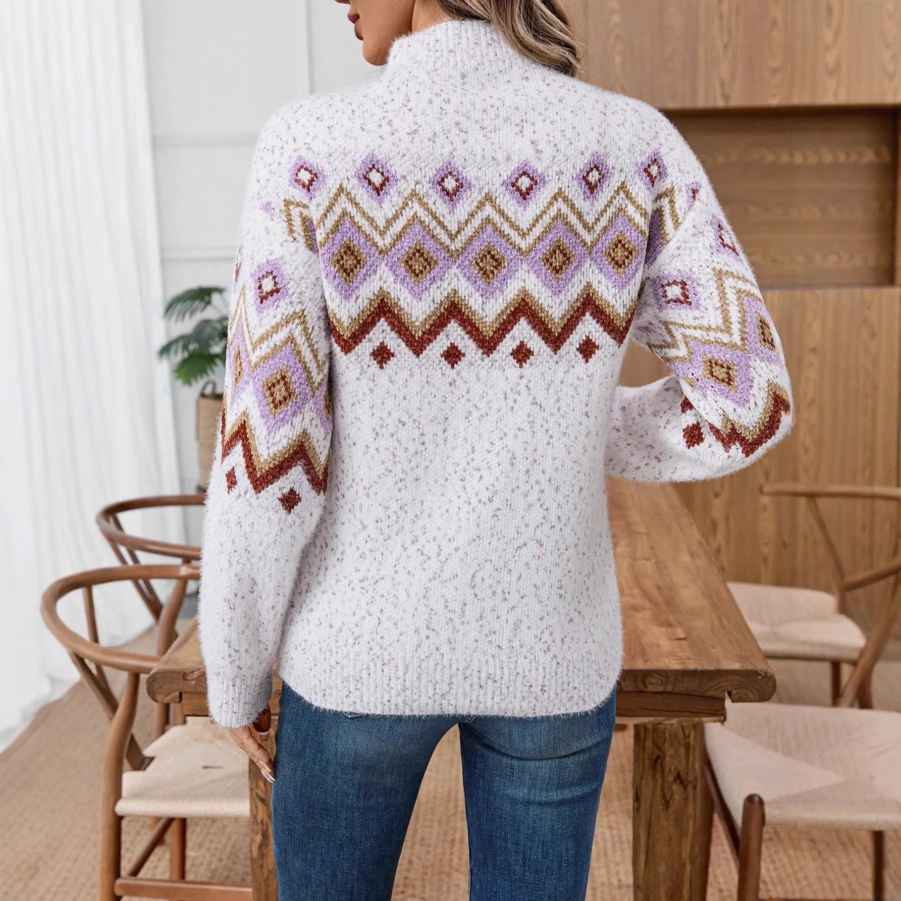White women's half turtleneck sweater with geometric jacquard pattern and loose long sleeves.