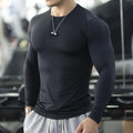 Men's black fitness tights with long sleeves and slim fit design for exercise