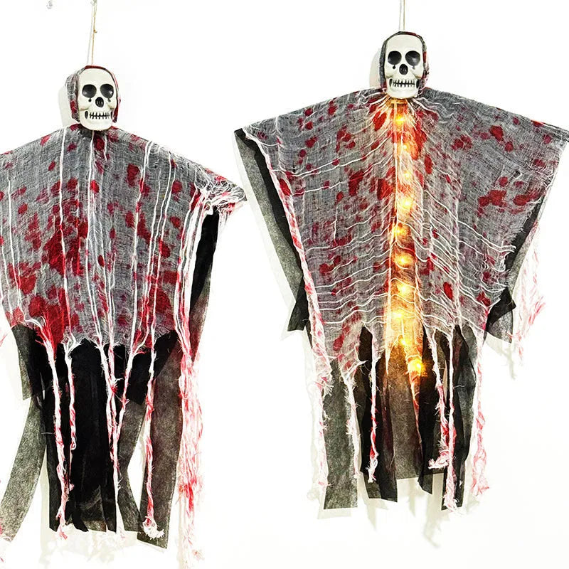 Halloween decoration showing a luminous blood-dyed plastic skull with a hanging ghost outdoor ornament