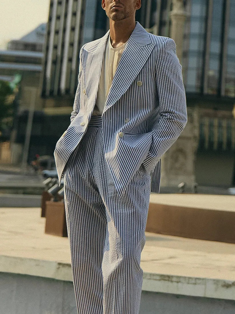 Blue and white striped polyester suit set with blazer and trousers on a hanger