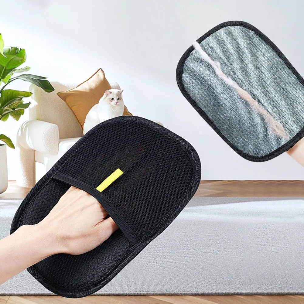 Black pet hair removal glove with silicone bristles on a hand, grooming a dog.