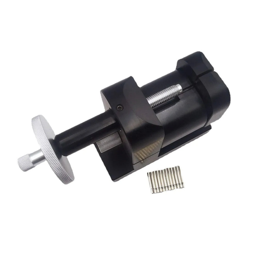 Steel alloy watch strap removal tool with spring mechanism on a work surface
