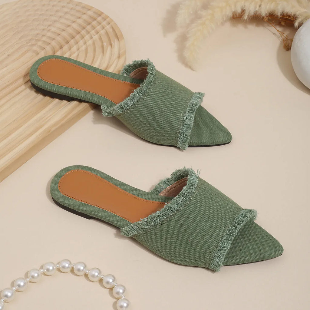 Women's flat denim slippers with tassel detail in apricot colour on a white background.