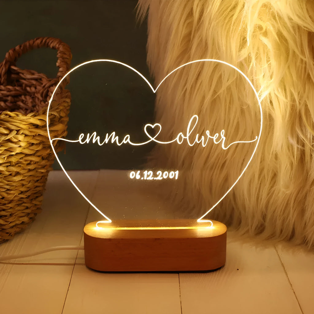 Custom couple names and date engraved on a transparent acrylic LED night light.
