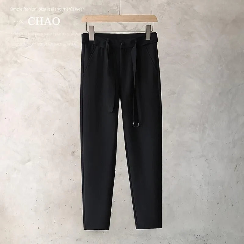 Boys slim straight trousers in wool blend fabric on a hanger, showing tapered leg