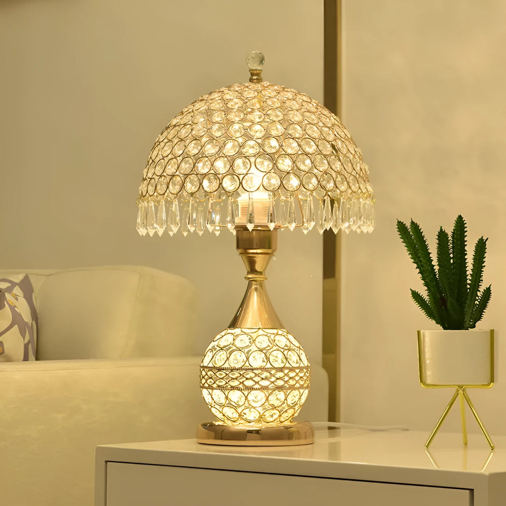 Gold crystal desk lamp with iron art base on wooden bedside table