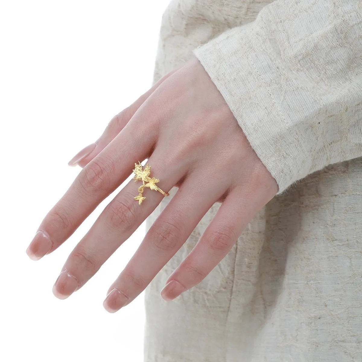 Women's adjustable silver ring with a wild butterfly design, shown in white gold and 18K gold colour finishes.
