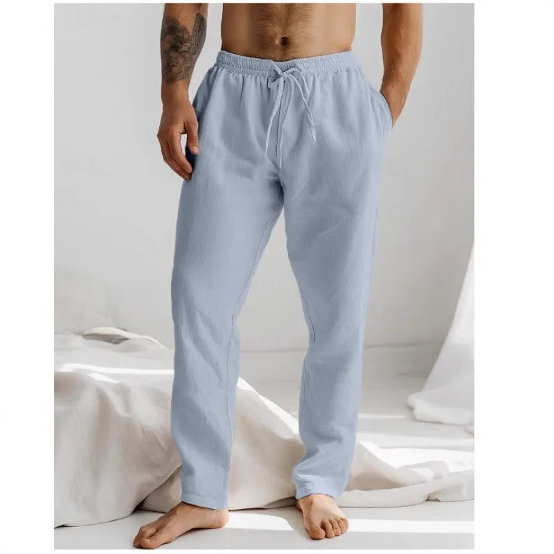Men's light grey loose-fit cotton linen summer trousers with an elastic drawstring waist on a plain background.