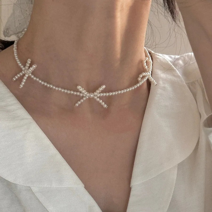 White geometric bow pearl necklace for women with adjustable 31-40cm length