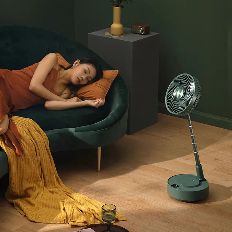 Green telescopic floor fan extended to vertical position with remote control