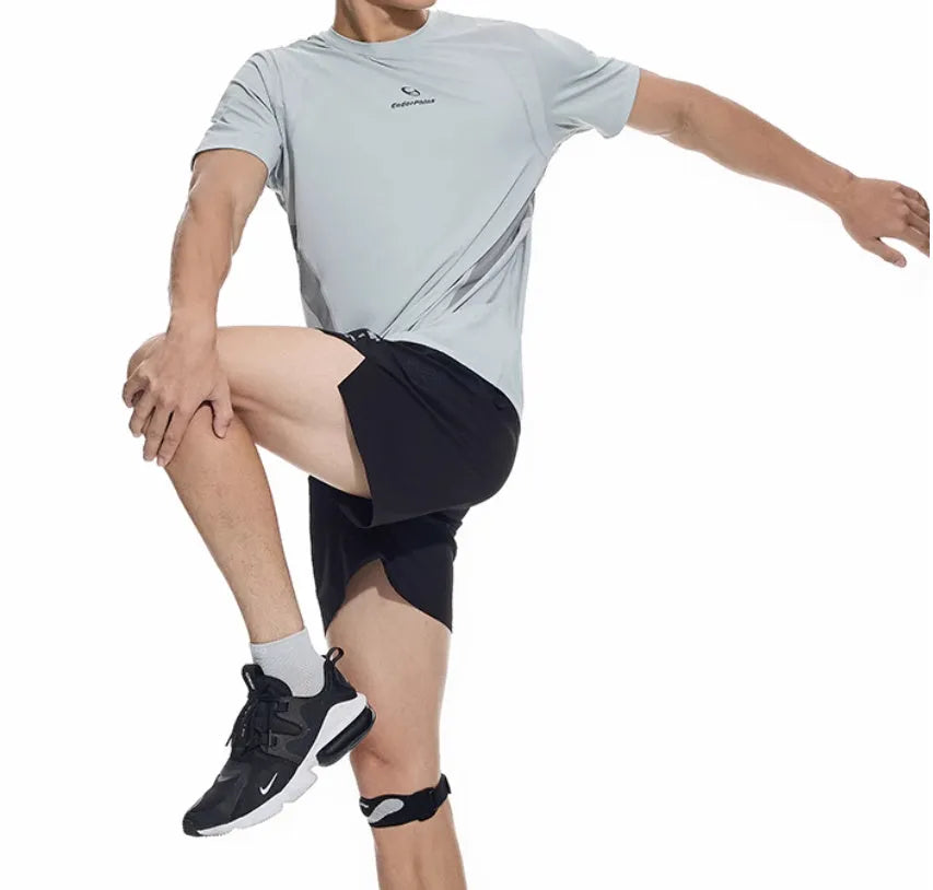 Men's black four-point running shorts with laser stitching on a flat surface, showing stretch fabric.