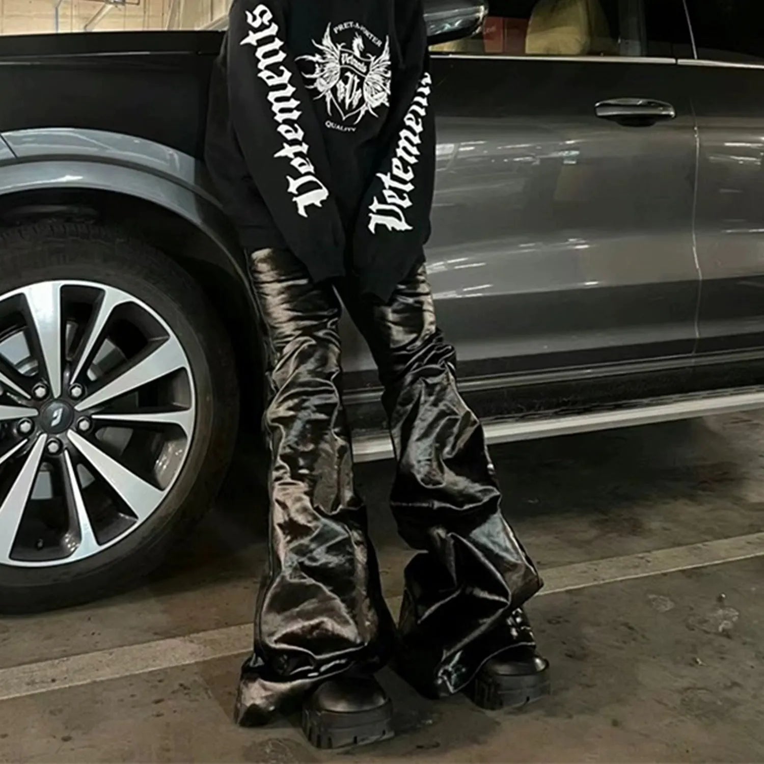 Black coated patent leather straight-leg jeans with shiny finish and cotton denim construction