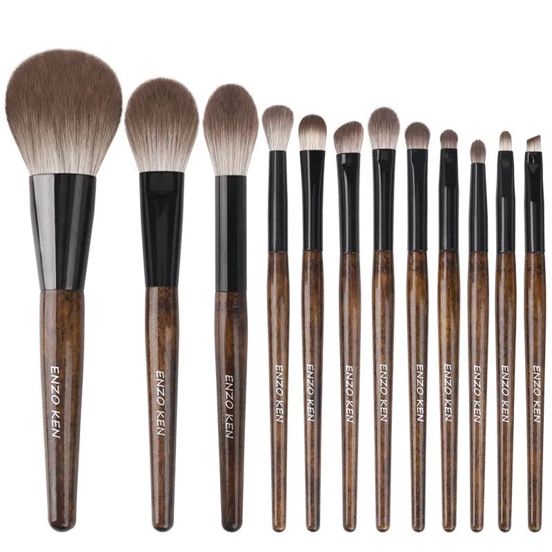 12 makeup brushes with wooden handles stored in a black PU roll, showing the powder foundation brush.